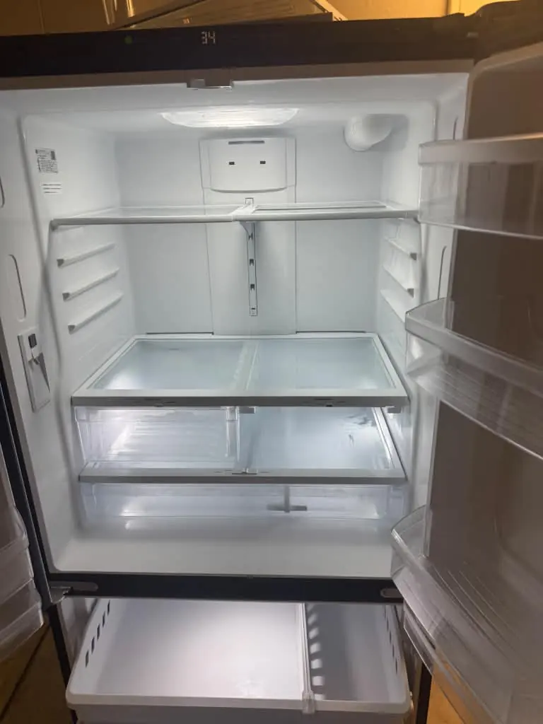 Empty refrigerator with clean shelves and drawers
